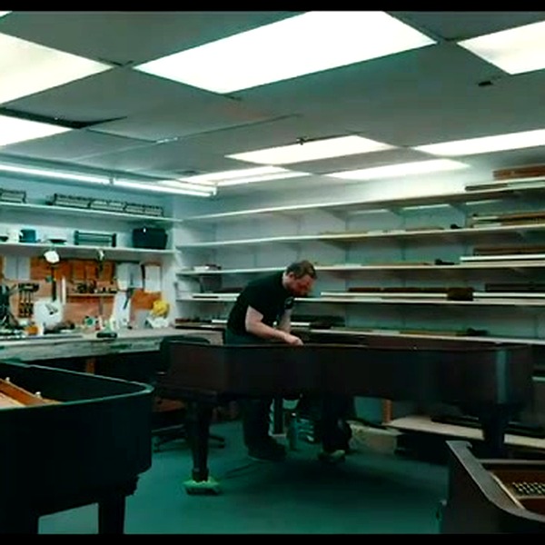 Craftsmen working on piano actions in the regulation room
