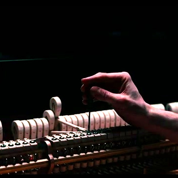 Master craftsman hands working on piano keys